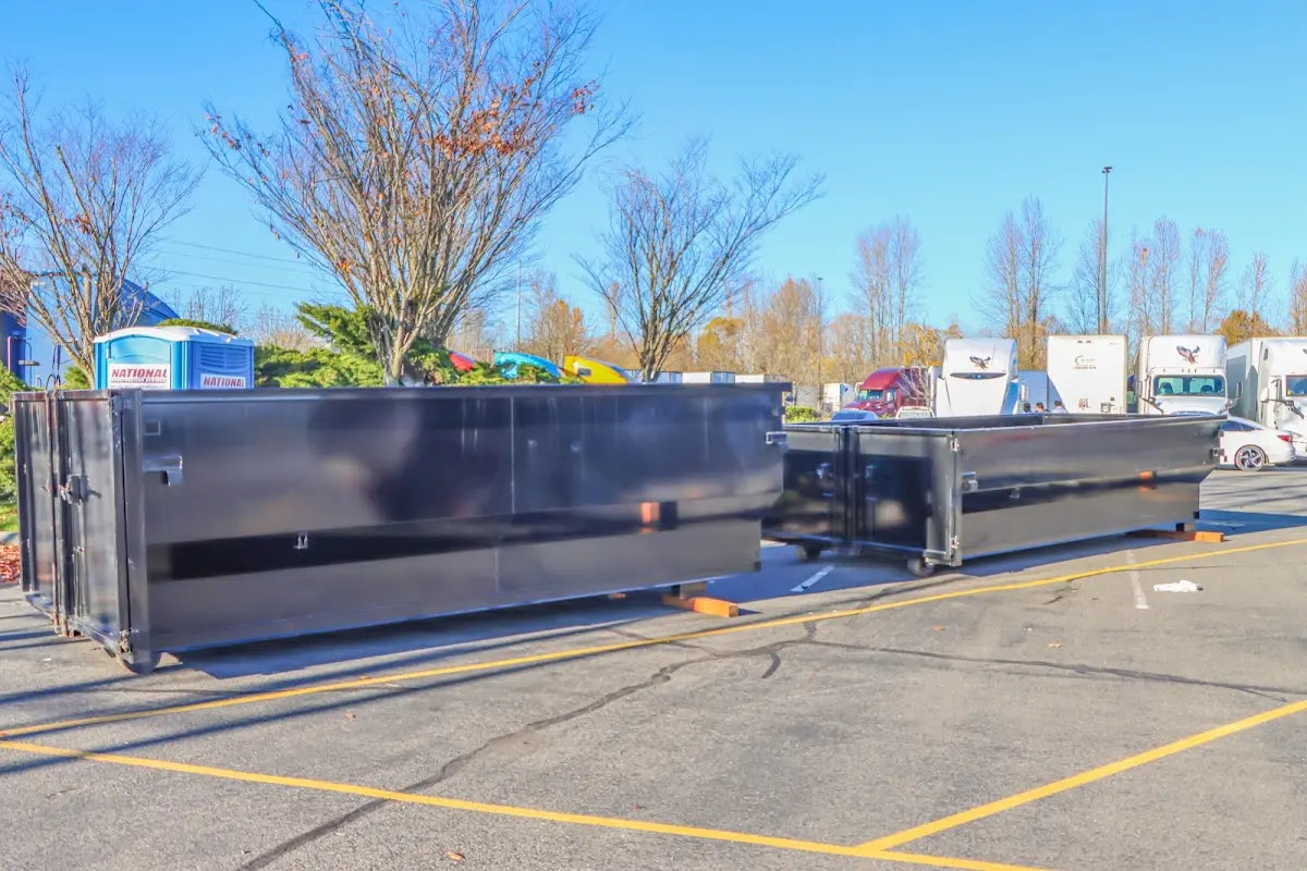 Professional dumpster rental service with roll-off container on residential driveway in Scottsboro